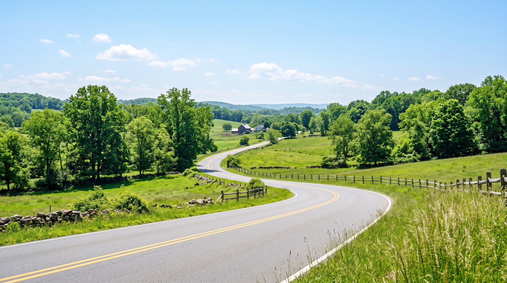 An open two-lane road curving gently through green New Jersey countryside