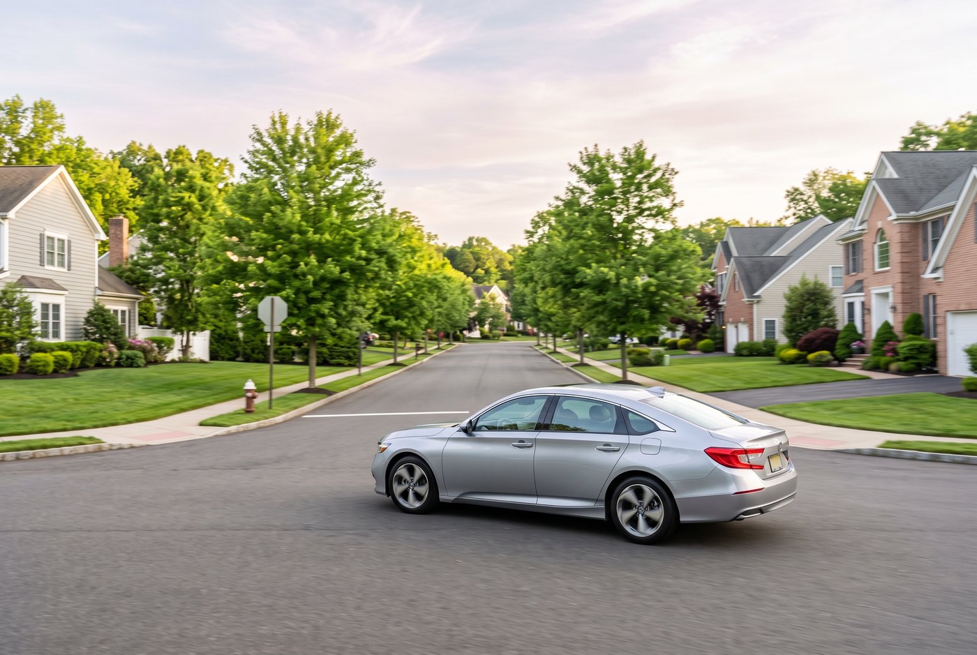 Silver driving-school car on a smooth suburban residential road
